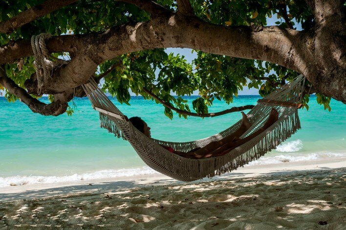 Man in a hammock by the sea