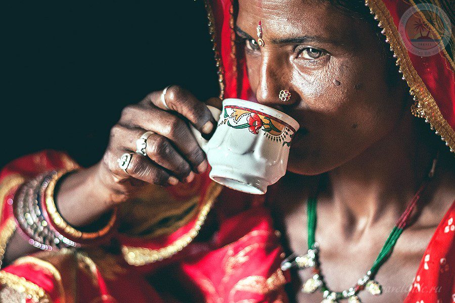 Женщина индианка в национальном наряде пьёт чай